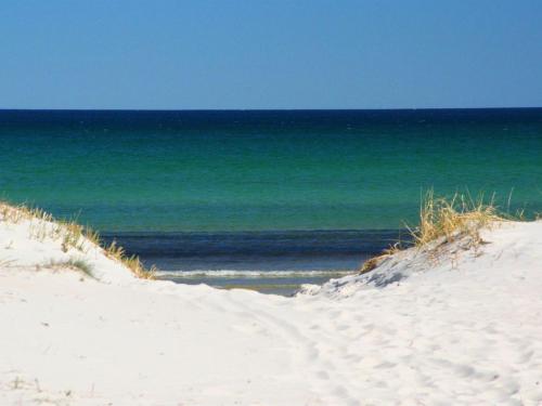 a sandy beach with the ocean in the background at Holiday Home Ødmar - 400m from the sea by Interhome in Neksø