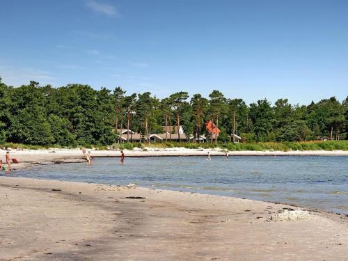 a group of people playing in the water on the beach at Holiday Home Ødmar - 400m from the sea by Interhome in Neksø