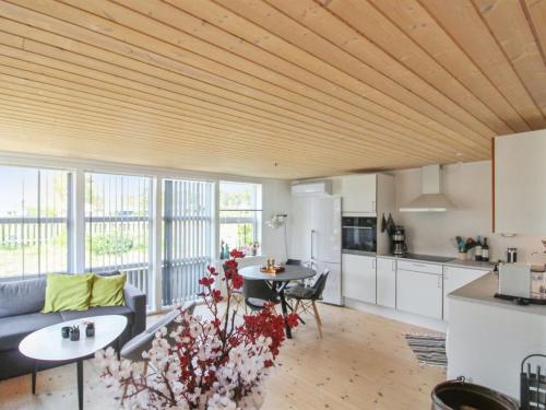 a kitchen and living room with a wooden ceiling at Holiday Home Algeth - 350m from the sea by Interhome in Neksø