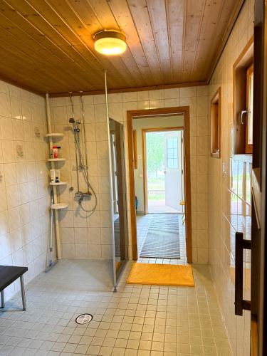 a bathroom with a shower and a glass door at Northern Lights Lakehouse in Rovaniemi