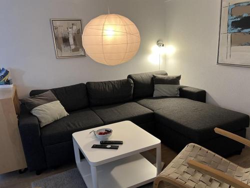 a living room with a couch and a table at Apartment Thyrne - 500m from the sea by Interhome in Gudhjem
