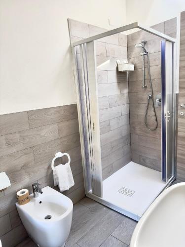 a bathroom with a shower and a toilet and a sink at Giardini B&B in Modena