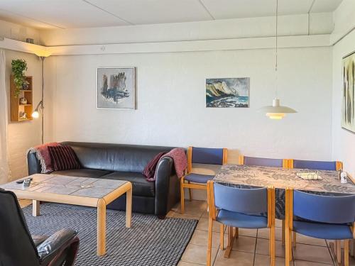 a living room with a couch and a table at Apartment Erica - 6km from the sea by Interhome in Åkirkeby