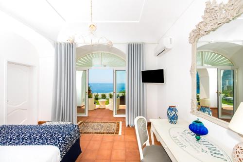 a bedroom with a bed and a view of the ocean at La Casa di Peppe in Positano