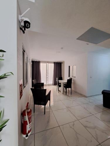 a living room with chairs and a table in it at Pensiòn Cerdà 112 in Alicante