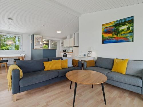 a living room with a couch and a table at Holiday Home Esben - 350m from the sea by Interhome in Allinge