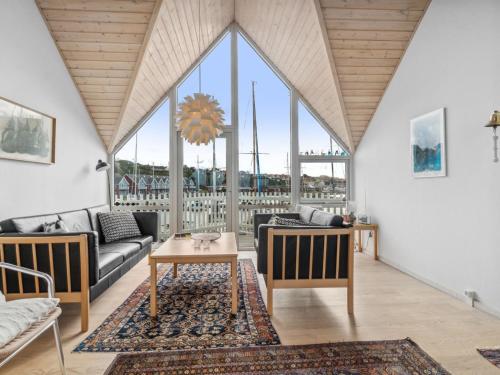 a living room with a couch and a table at Holiday Home Frigg - 10m from the sea by Interhome in Hasle