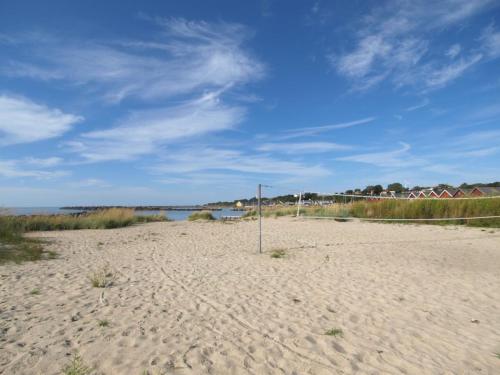 a volleyball net on a sandy beach near the water at Holiday Home Eija - 5m from the sea by Interhome in Hasle
