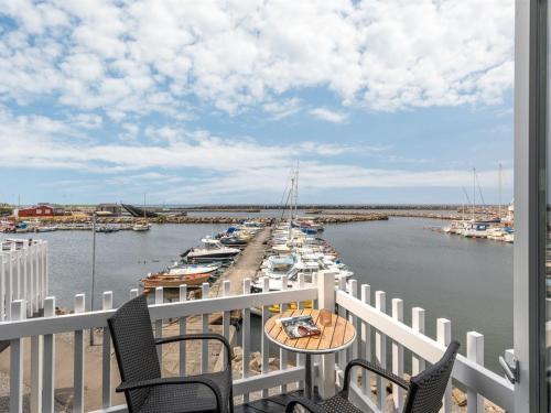 a balcony with a view of a marina with boats at Holiday Home Eija - 5m from the sea by Interhome in Hasle
