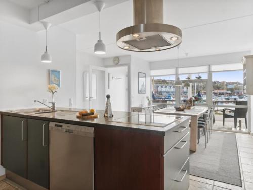 a kitchen with a large island and a dining room at Holiday Home Fridhild - 10m from the sea by Interhome in Hasle