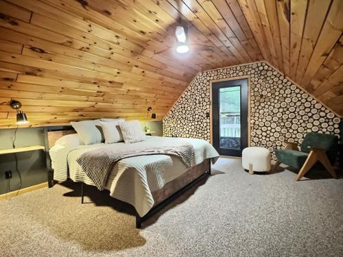 a bedroom with a bed and a wooden ceiling at Cabin in Ellicottville, Fire Place & Hot Tub in West Valley
