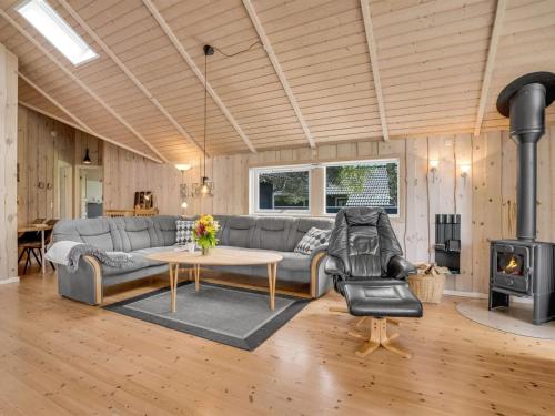 a living room with a couch and a stove at Holiday Home Alger - 800m from the sea by Interhome in Marielyst