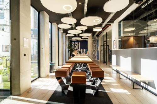 a hallway with tables and chairs in a building at The ASH in Antwerp