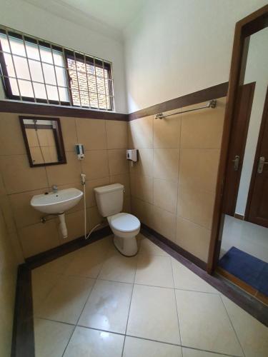 a bathroom with a toilet and a sink at MB Apartments & Hotel Medan in Sunggal