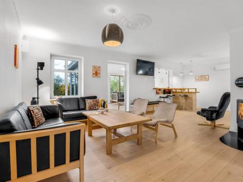 a living room with a couch and a table at Holiday Home Thorward - 1-5km from the sea by Interhome in Idestrup