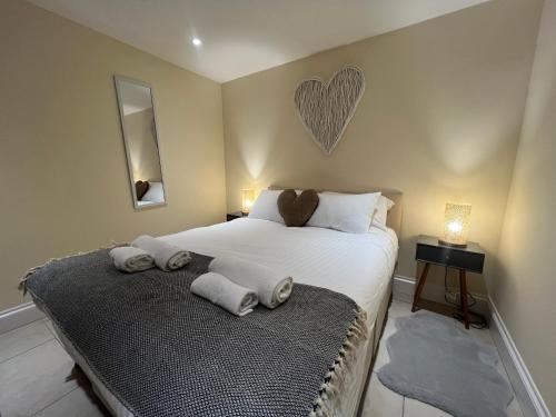 a bedroom with a bed with towels on it at Spring Cottage in Ulverston