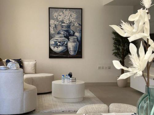 a living room with blue and white vases on the wall at Beach Front 03 bedroom villa plus maid room in Al Ḩamrīyah
