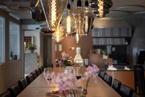 a long table with wine glasses and flowers on it at Hotel Sonne St. Moritz 3* Superior in St. Moritz