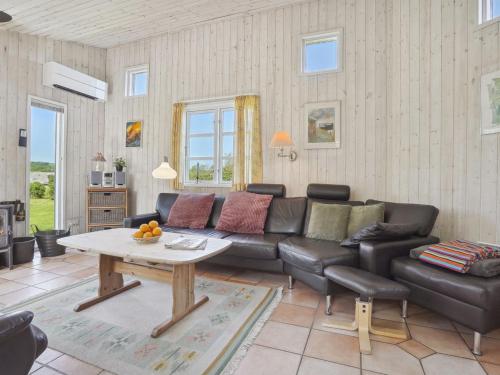 a living room with a couch and a table at Holiday Home Alma - 400m from the sea by Interhome in Augustenborg
