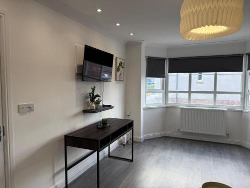 a living room with a table and a window at ResiLets - Berwick House - Large 4 Bed Townhouse - Contractor stays in Cowpen