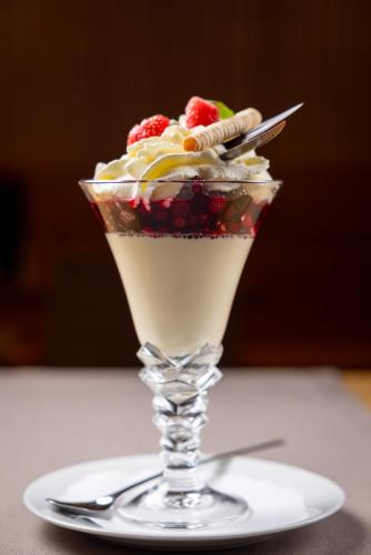 a dessert in a martini glass on a plate at Hotel Sonne St. Moritz 3* Superior in St. Moritz