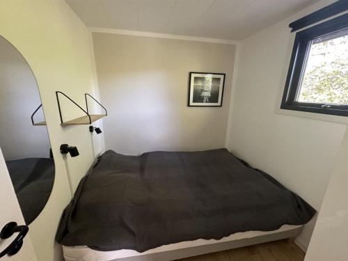 a bedroom with a bed and a window at Holiday Home Ady - 150m from the sea by Interhome in Augustenborg