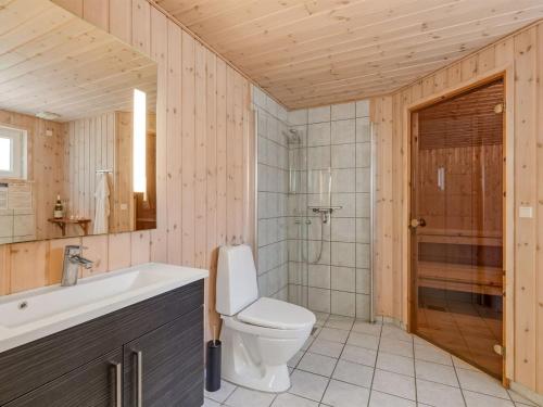 a bathroom with a toilet and a sink at Holiday Home Hertta - 200m from the sea by Interhome in Marielyst