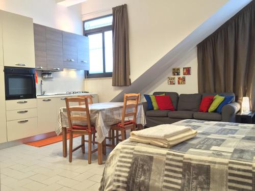 a kitchen and living room with a couch and a table at Casa Vacanza in Zafferana Etnea