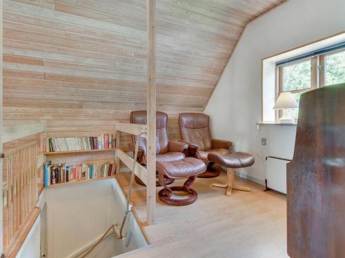 a home office with two chairs and a book shelf at Holiday Home Ilja - 400m from the sea by Interhome in Sønderby