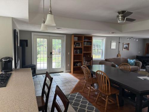 a kitchen and living room with a table and chairs at Old Orchard Kirtland, Ohio 