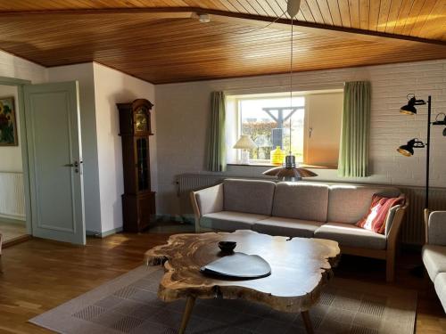 a living room with a couch and a coffee table at Holiday Home Edithe - 250m from the sea by Interhome in Augustenborg