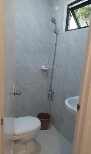 a bathroom with a toilet and a sink at Uno's Krib - Pilar in Pilar