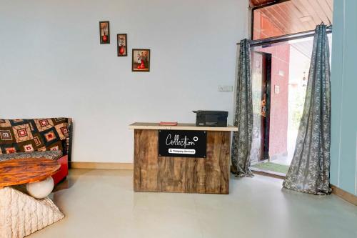 a living room with a table and a window at Collection O Malavli Lonavala Hill View in Lonavala