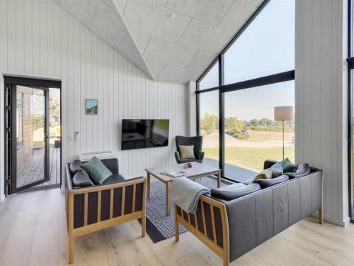 a living room with two couches and a tv at Holiday Home Gojana - 400m from the sea by Interhome in Nordborg