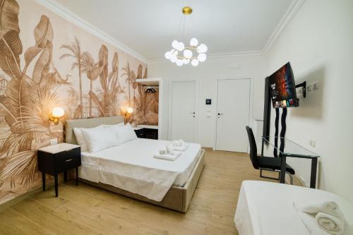 a bedroom with a bed and a table and a chair at Radio Suites in Rome