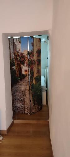 a room with a window with a picture of a street at Casa nella roccia in Bomarzo