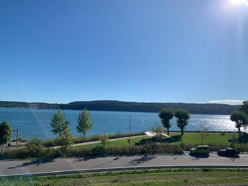 a parking lot next to a large body of water at Gästehaus zum Felsen in Überlingen