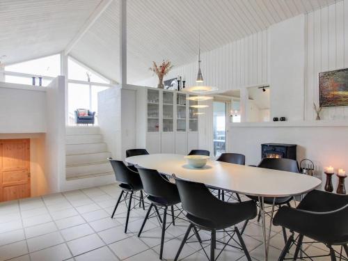 a kitchen and dining room with a table and chairs at Holiday Home Hansina - 500m from the sea by Interhome in Fanø