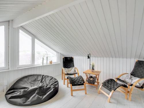a room with chairs and a bean bag chair at Holiday Home Hansina - 500m from the sea by Interhome in Fanø