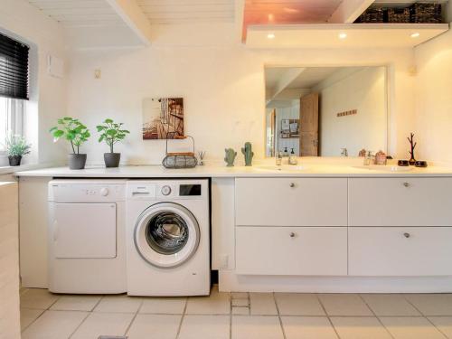 a kitchen with a washing machine and a sink at Holiday Home Hansina - 500m from the sea by Interhome in Fanø