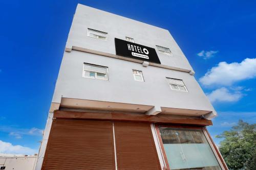 a white building with a sign on it at Townhouse Sector 33 Gurgaon in Gurgaon