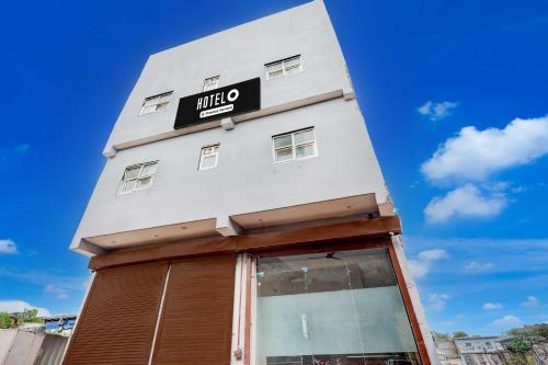 a white building with a black sign on it at Townhouse Sector 33 Gurgaon in Gurgaon