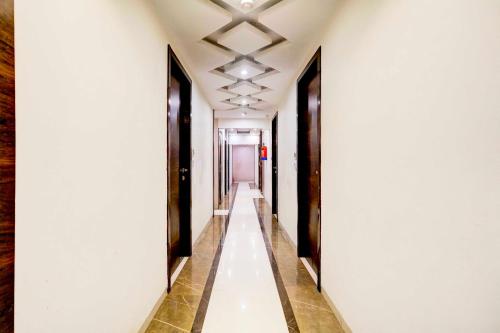 a corridor of a building with white walls and a long hallway at Collection O Mumbai Central in Mumbai