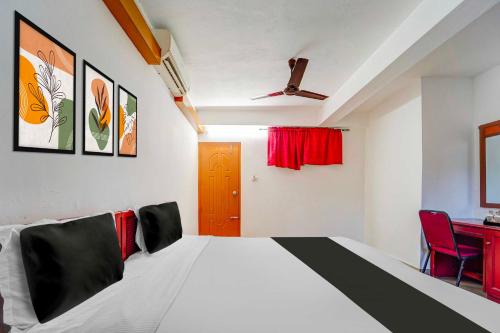 a bedroom with a large bed with a red door at Collection O Kottayam Near Caritas Hospital in Kottayam