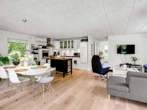 a kitchen and living room with a table and chairs at Holiday Home Maik - 1-5km from the sea by Interhome in Fanø