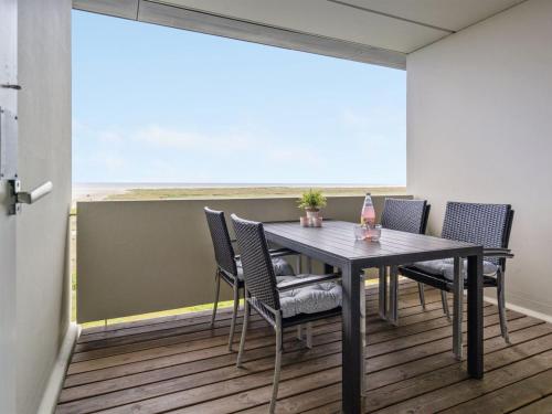 a dining room with a table and chairs and a large window at Apartment Edelina - 50m from the sea by Interhome in Fanø