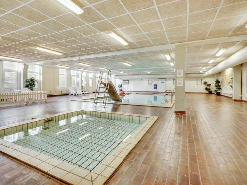 an empty room with a pool in the middle of a building at Apartment Edelina - 50m from the sea by Interhome in Fanø