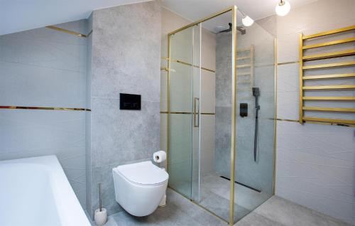 a bathroom with a toilet and a glass shower at Amazing Apartment In Nowecin With Wifi in Nowecin