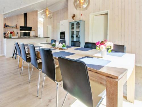 a dining room with a long table and chairs at Holiday Home Anuk - 2-3km from the sea by Interhome in Rømø Kirkeby