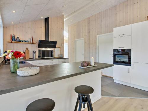 a kitchen with white cabinets and a counter top at Holiday Home Anuk - 2-3km from the sea by Interhome in Rømø Kirkeby